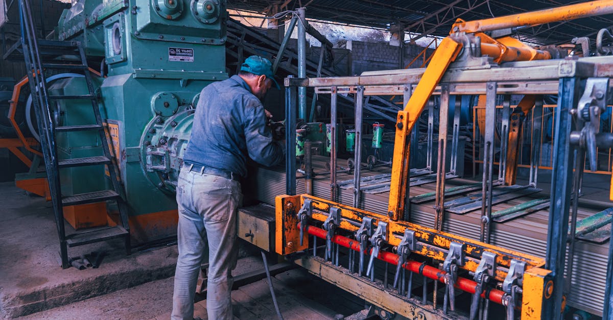 a factory worker operates heavy machinery in an industrial setting depicting a typical manufacturin