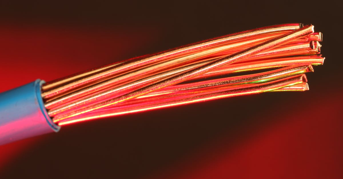 detailed image of copper wires illuminated by red light highlighting texture and color